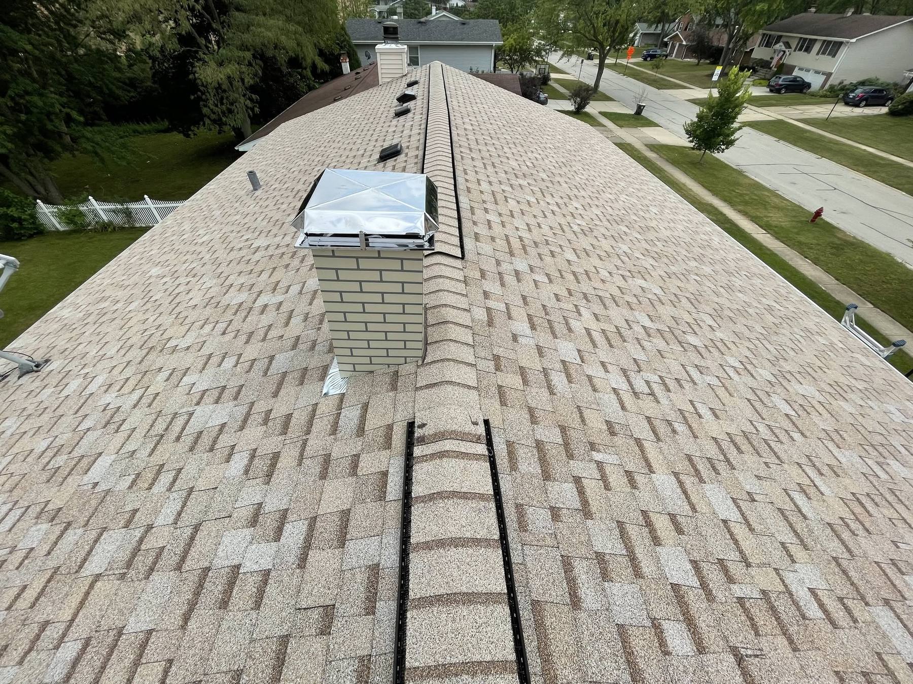 Roof replacement with new ridge vent and chimney cap in Streamwood, IL
