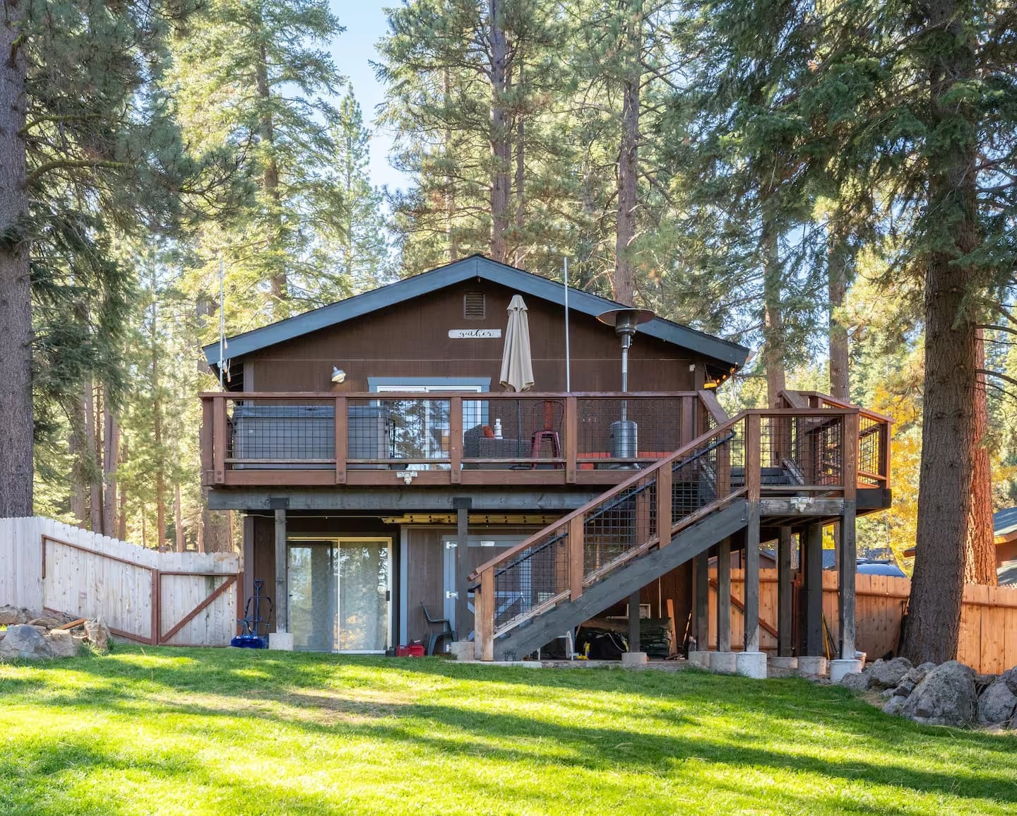 Truckee Mountain Stay exterior with a deck and grassy yard