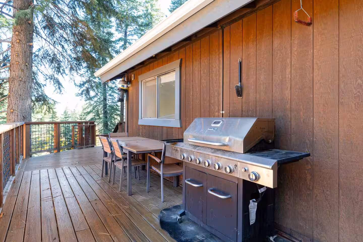 Deck with outdoor grill and dining table