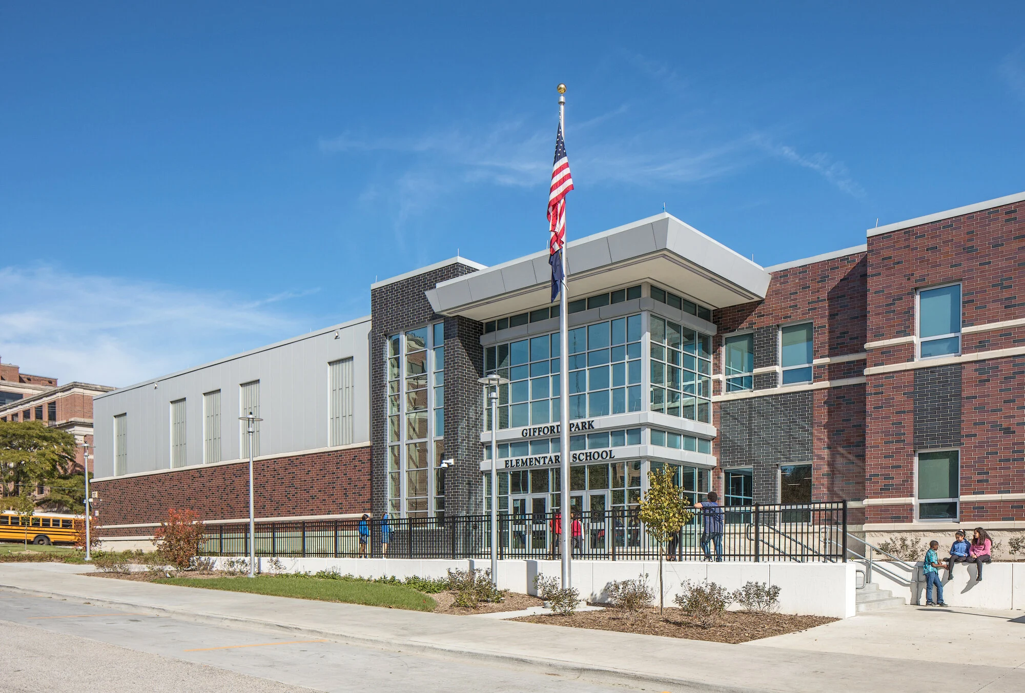 Exterior entrance of Gifford Park Elementary in Omaha with a brick facade and flag pole
