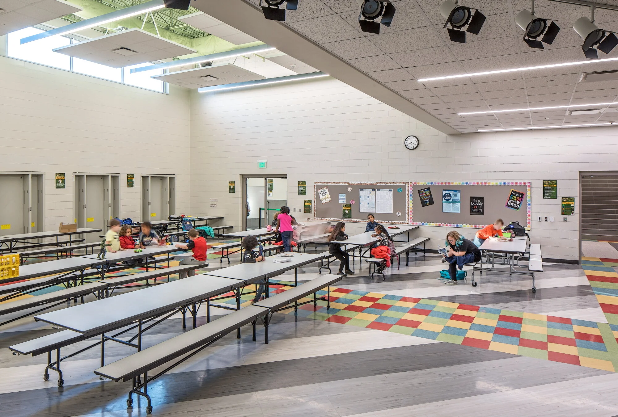 Cafeteria with folding tables and a multicolored floor