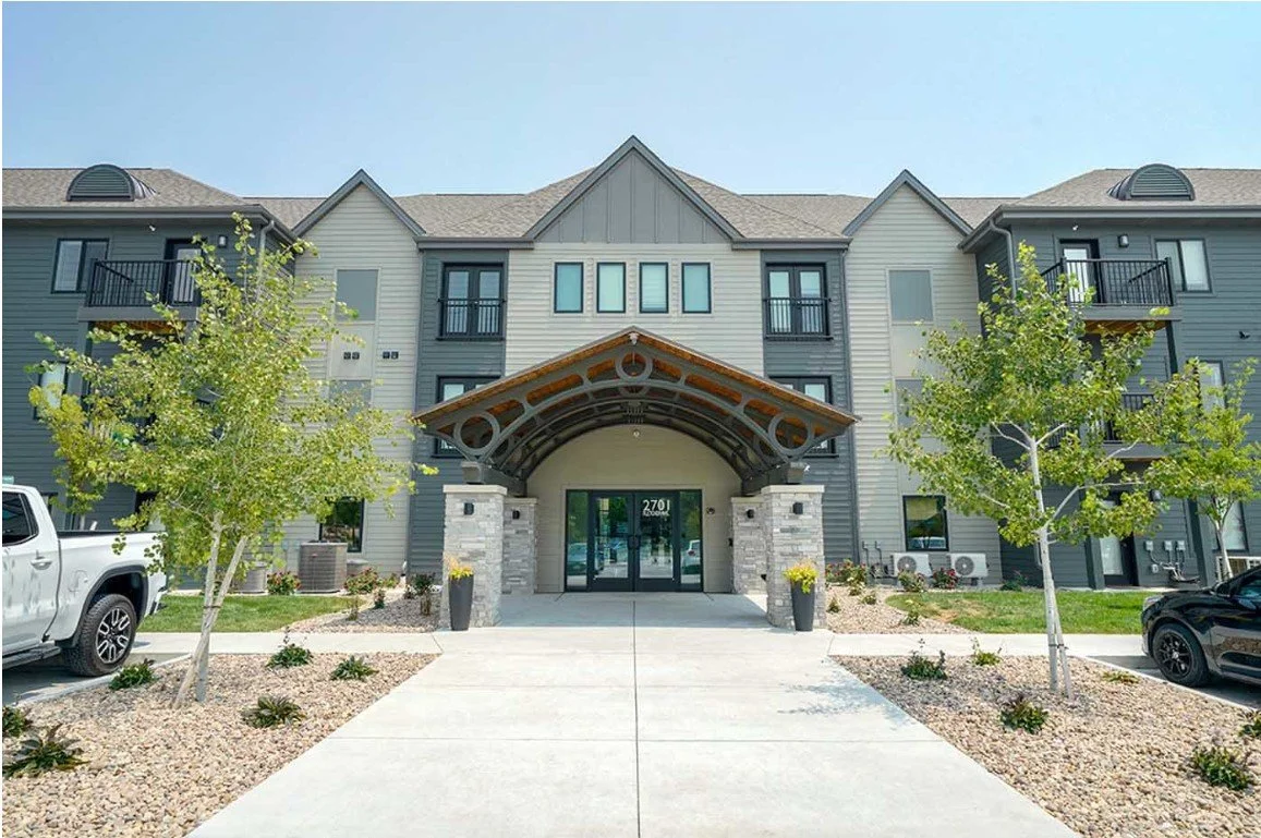 Exterior entrance of The Knock apartments in Lincoln with a timber-framed portico and landscaped drive
