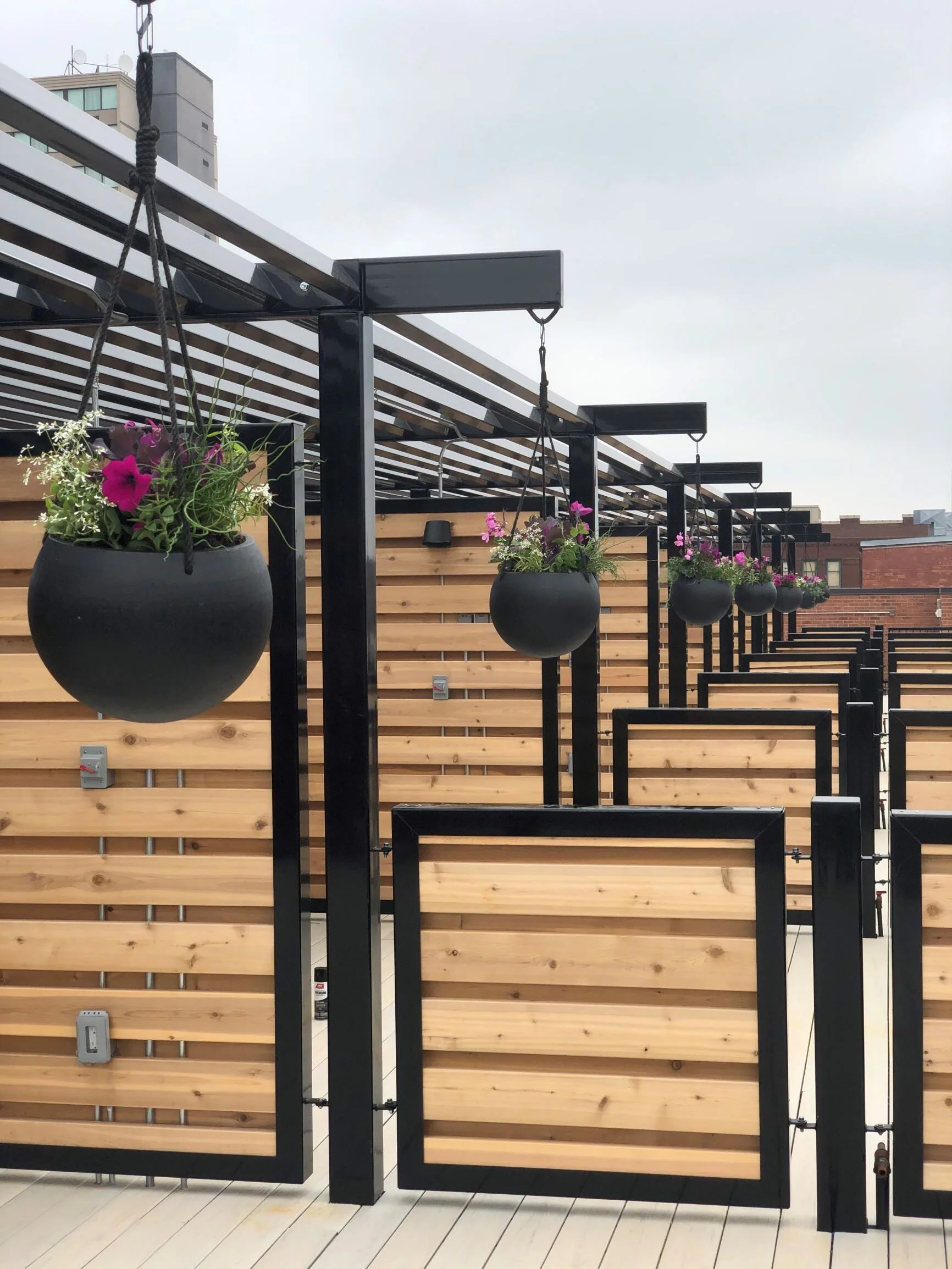 Rooftop terrace with a pergola, planters and privacy screens