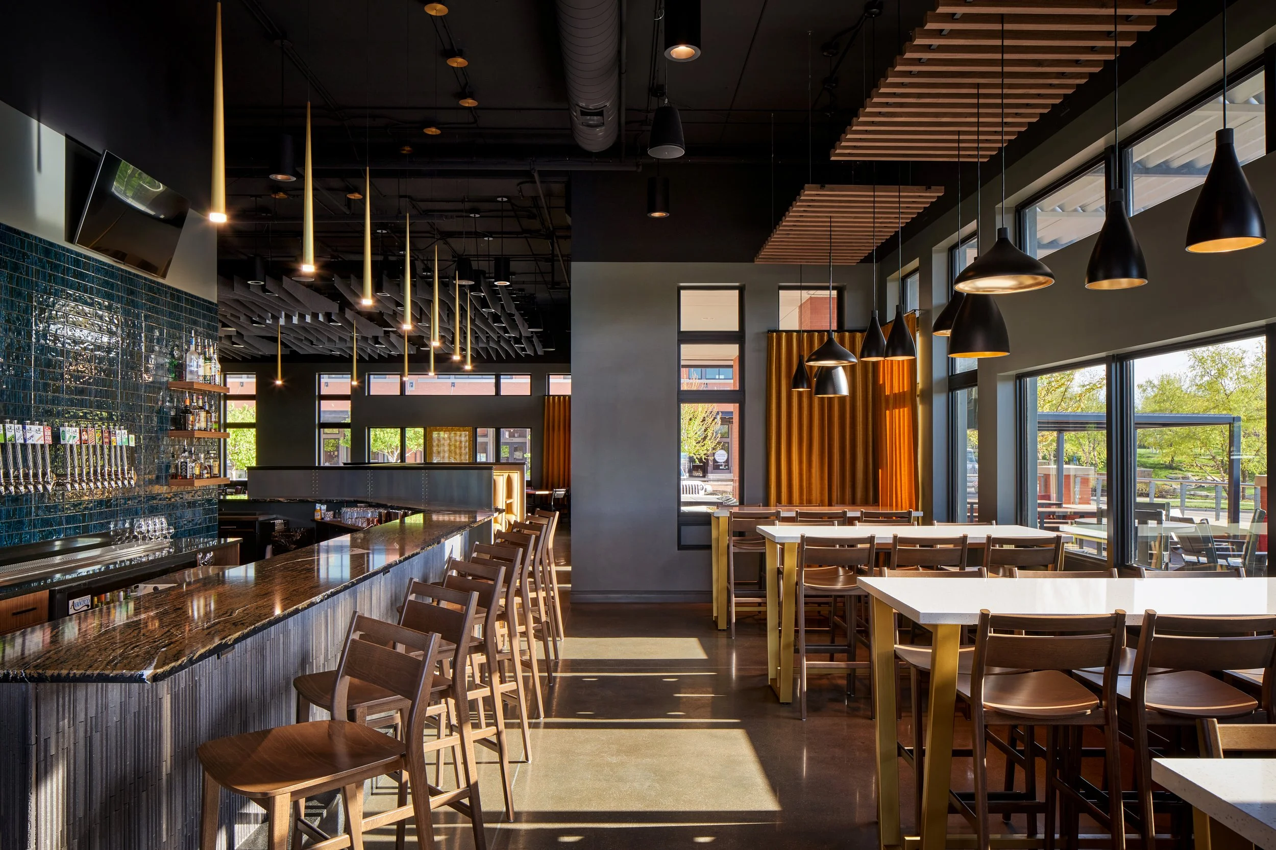 Bar-height dining with pendant lights and floor-to-ceiling windows
