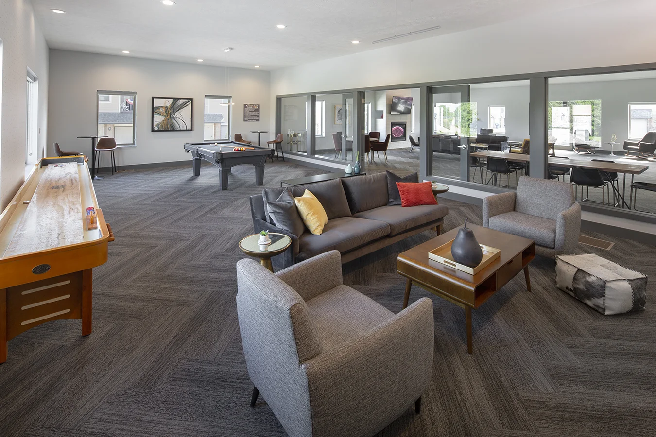 Clubhouse at The Villas at Mahoney Park in Lincoln with a shuffleboard table, gray sectional and pool table