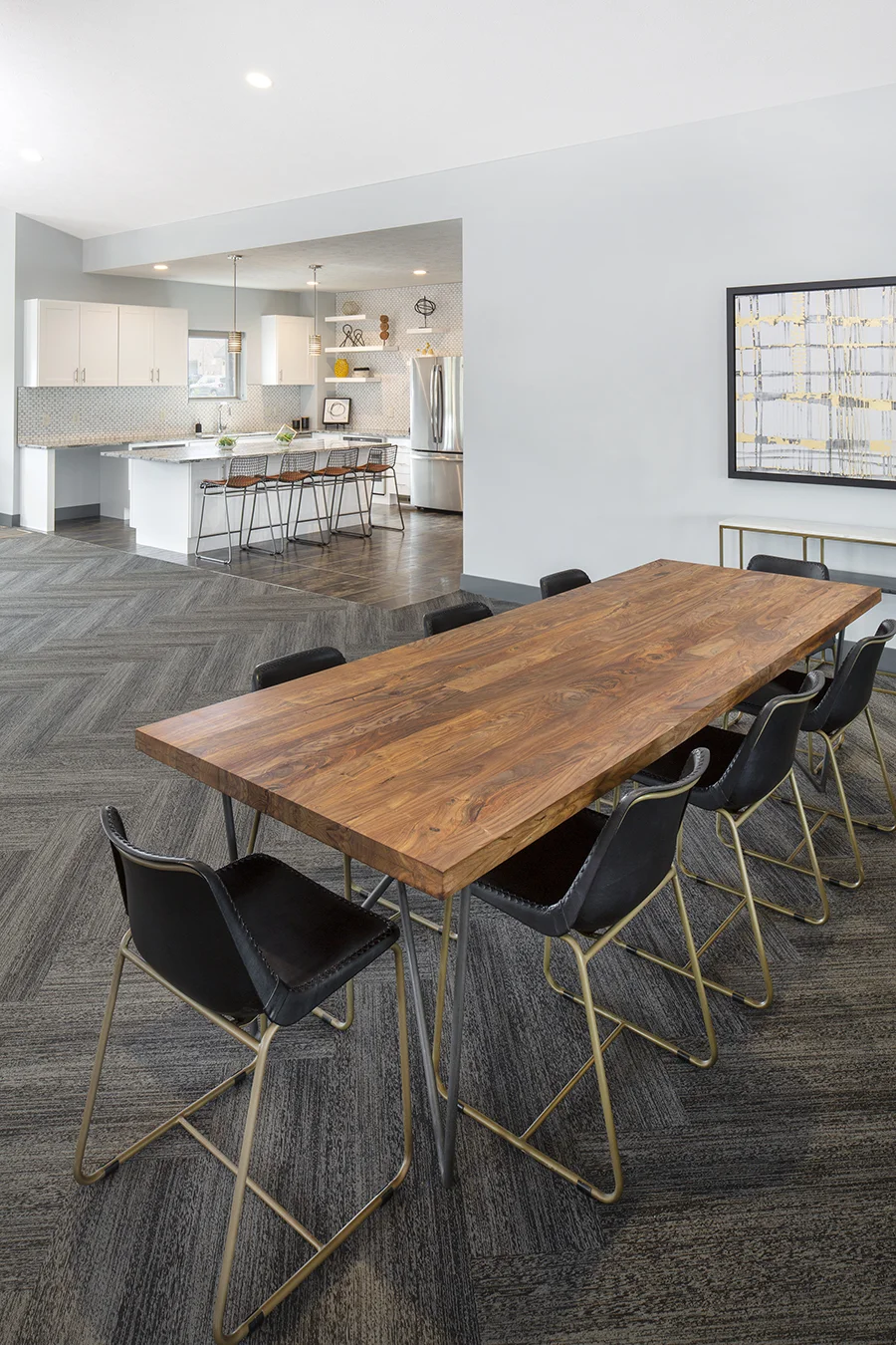 Live-edge wood dining table with black chairs in the clubhouse