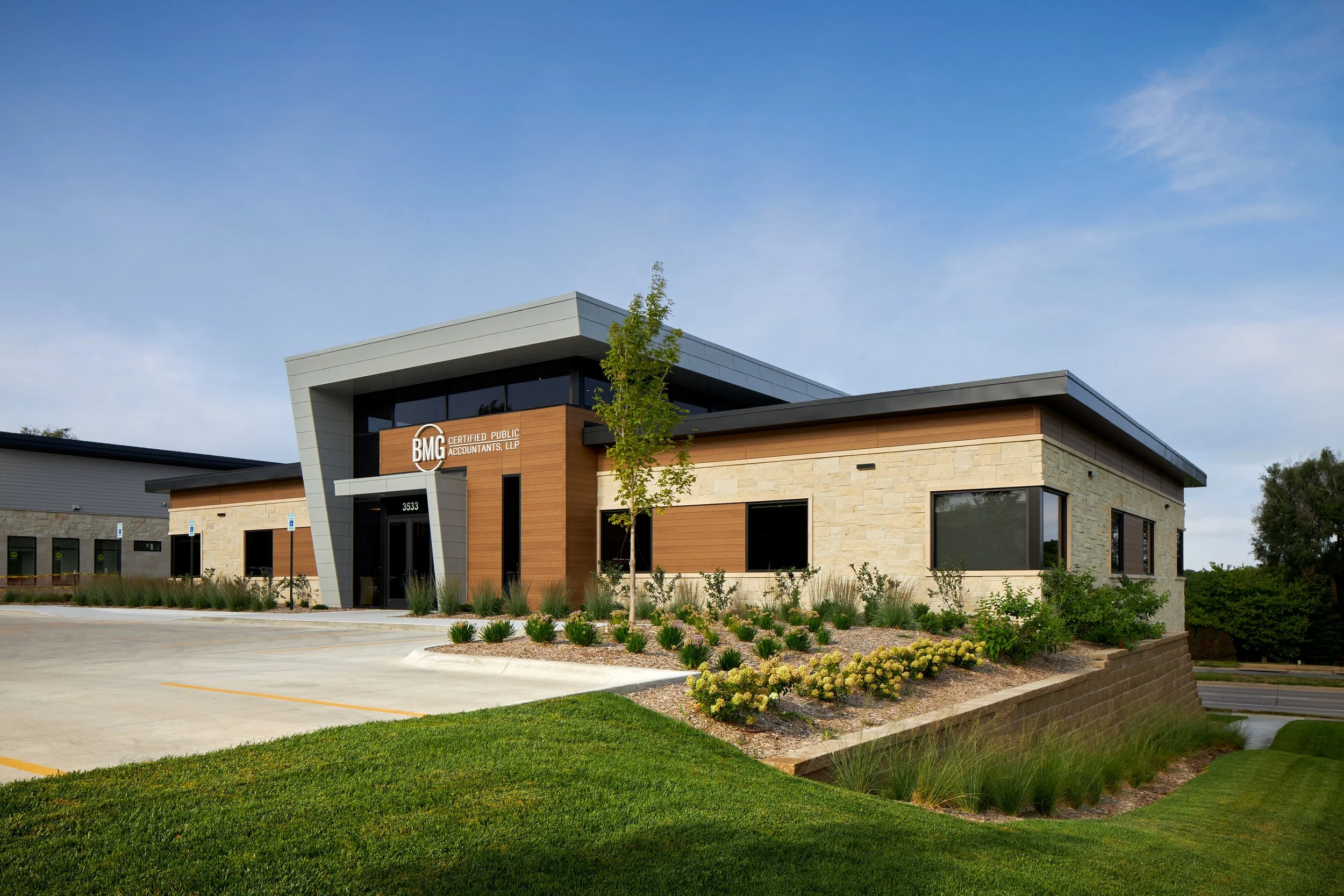 Exterior of the BMG CPAs office building with stone, wood and metal panel cladding
