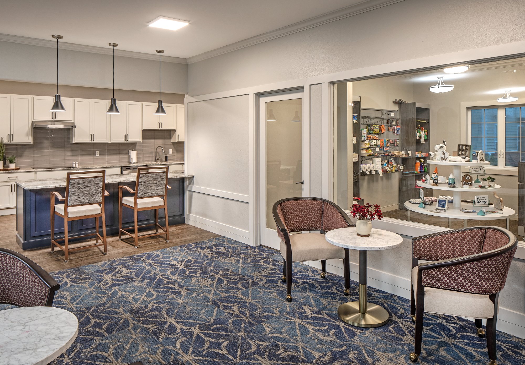 Bistro seating with marble tables, upholstered chairs and a cafe counter