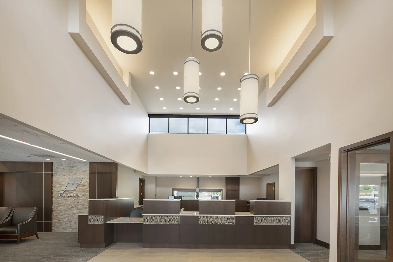 Five Points Bank lobby in Lincoln with a two-story ceiling, pendant lights and wood teller counter
