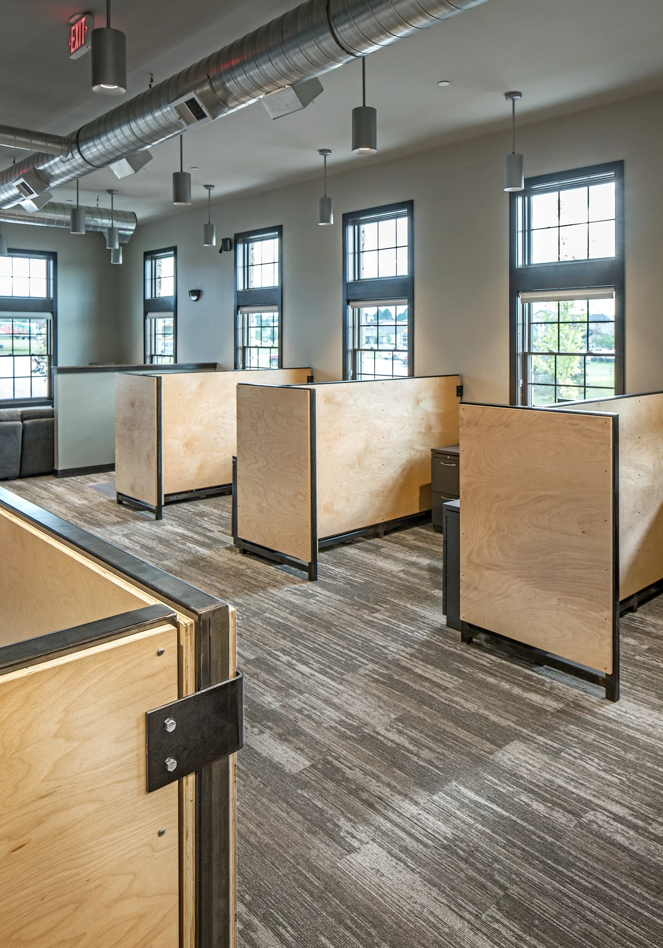 Workstations with plywood privacy panels and wood-look floor