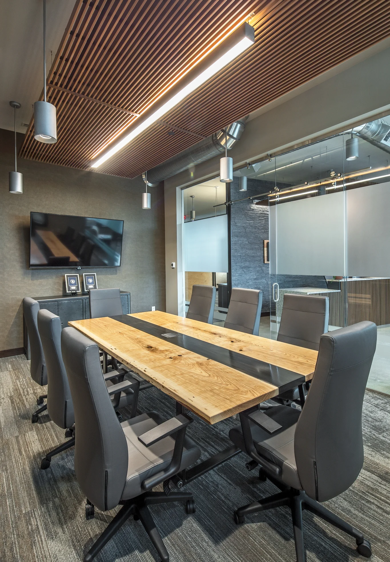 Conference room at Flagstone Financial in Lincoln with a live-edge table, gray chairs and wood slat ceiling