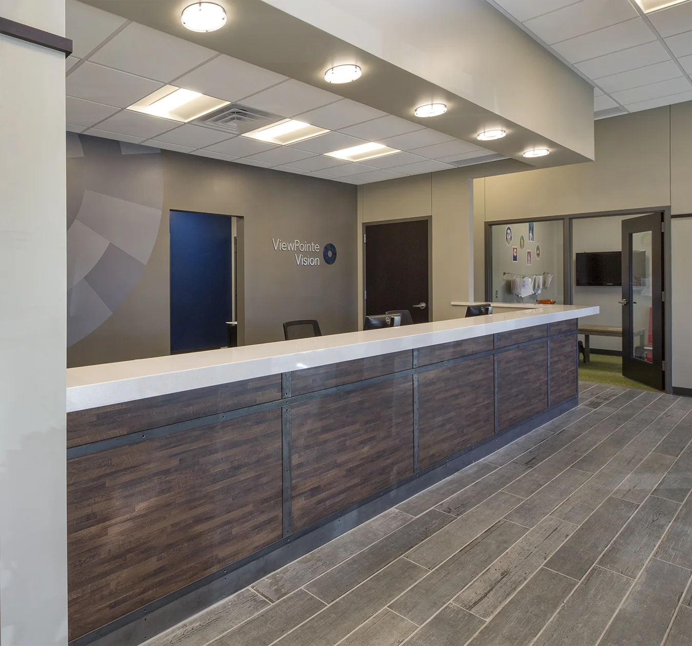 Optical reception desk with wood front and pendant lights