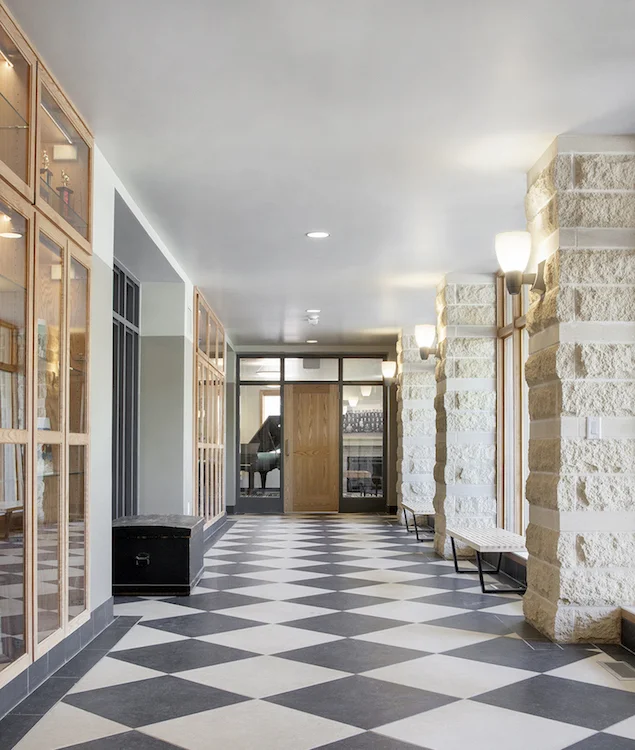 Entry hall with limestone columns and black and white checkered floor