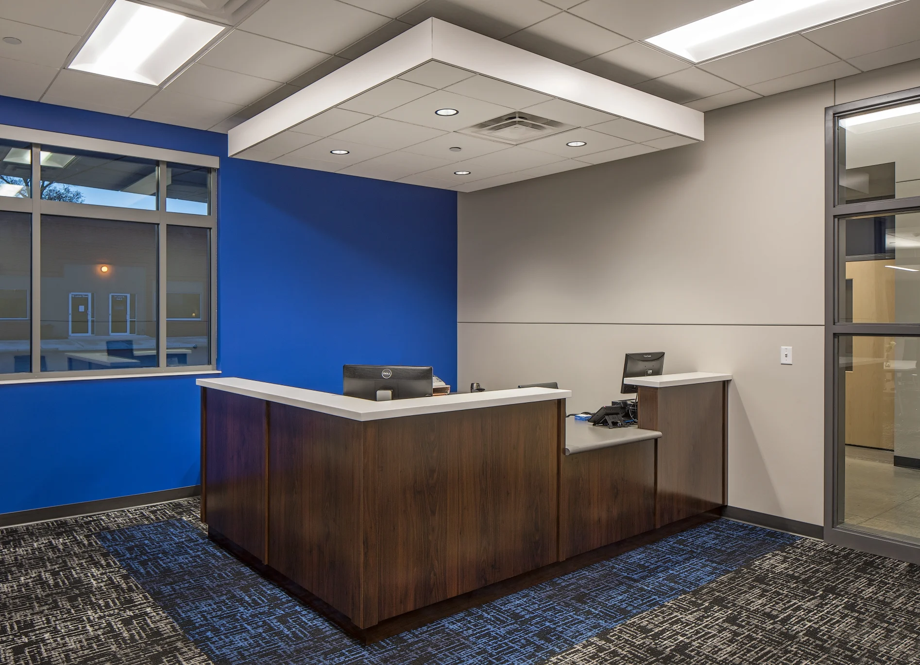 City Hall reception desk with a wood front and a blue accent wall