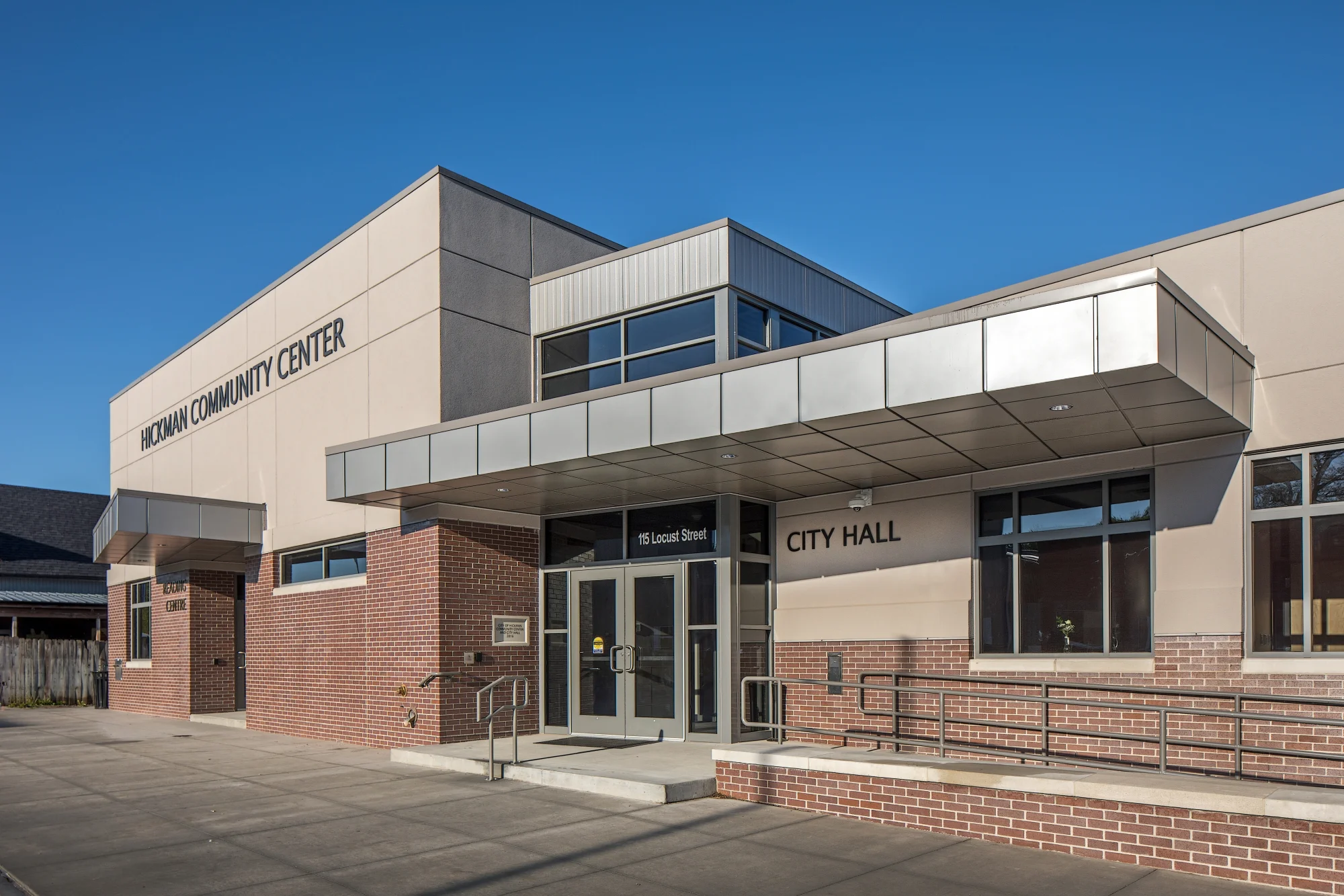 Front entrance of the Hickman Community Center with a metal canopy and brick base