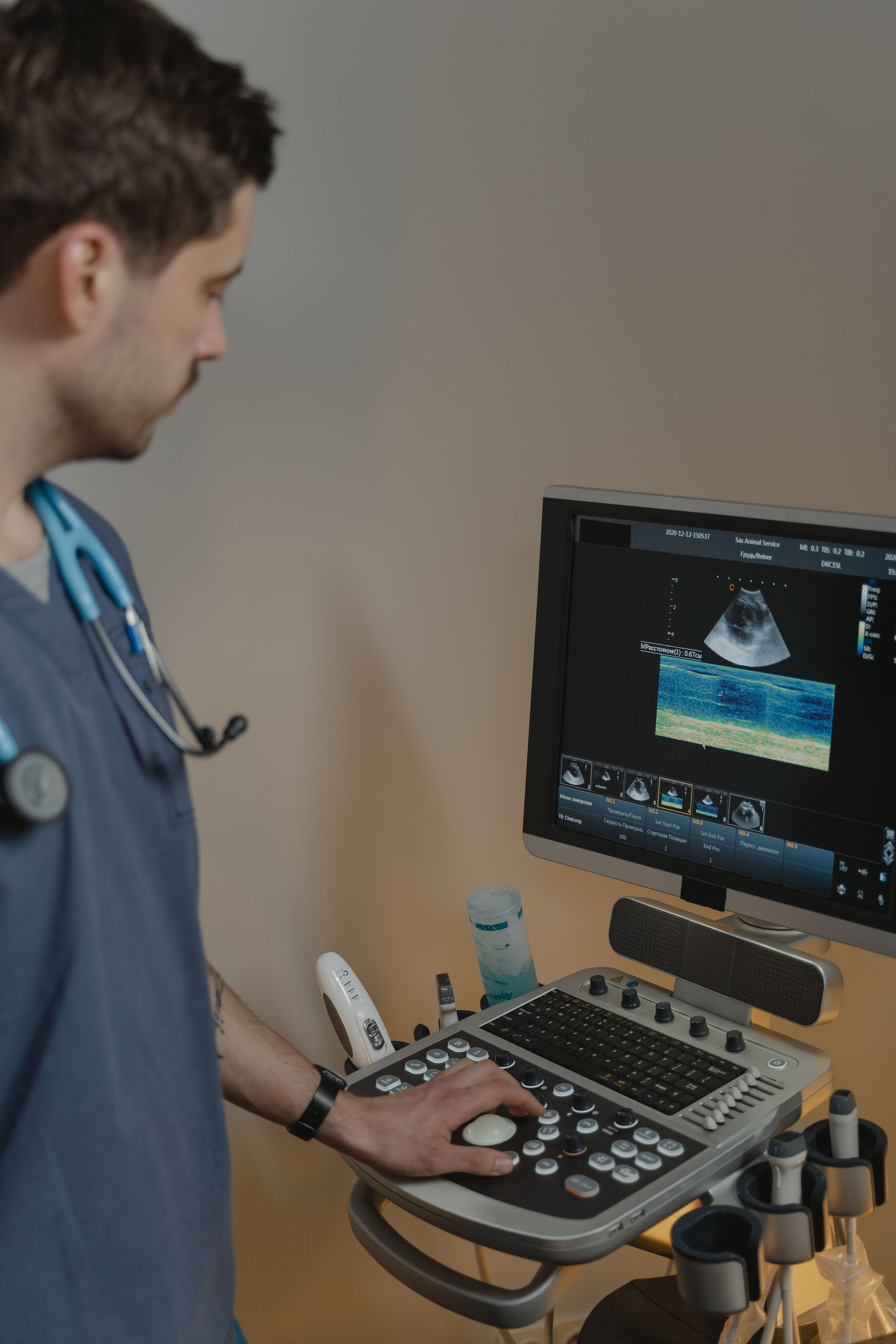 Cardiology clinician operating modern ultrasound equipment