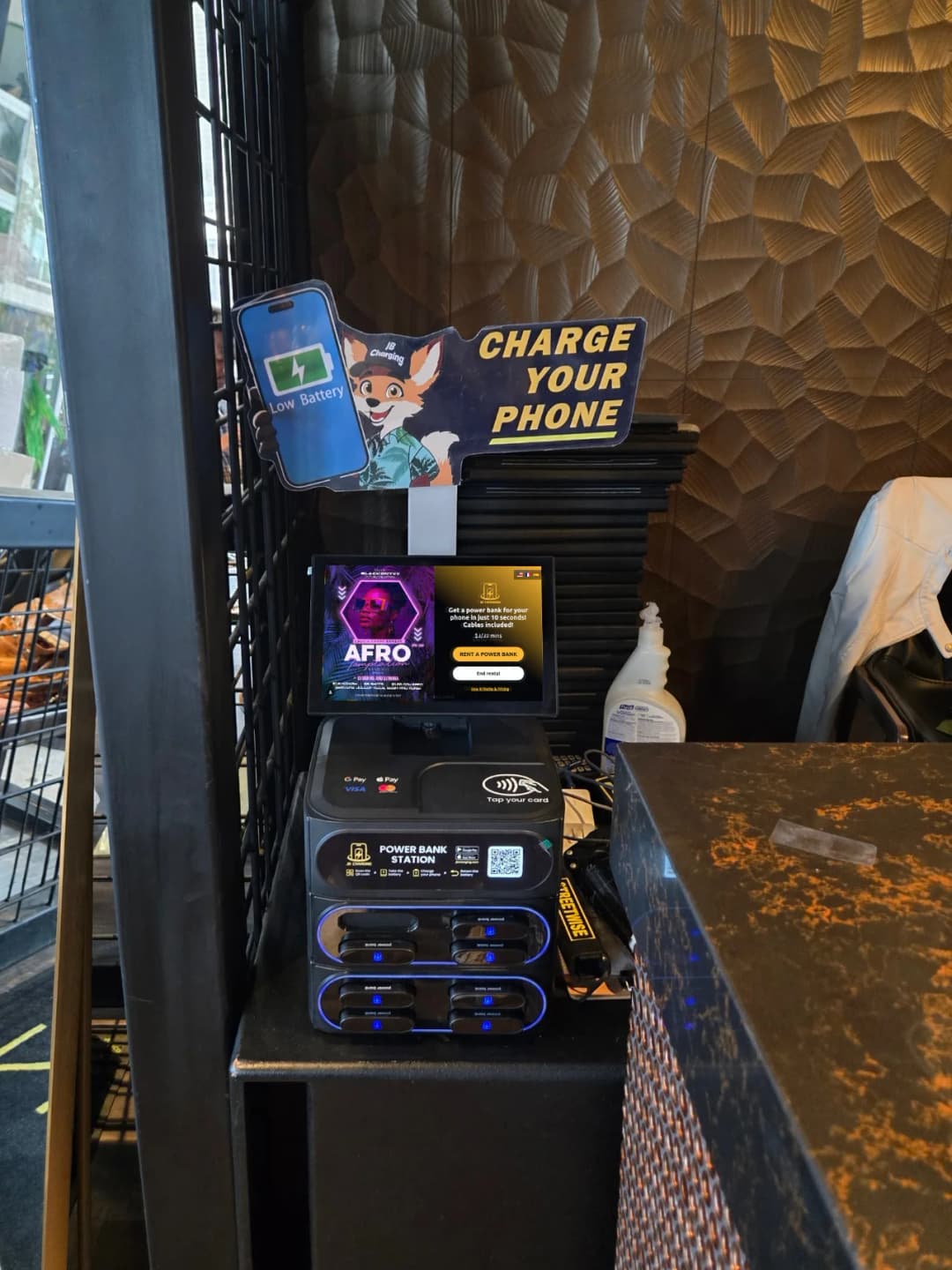 A JB Charging station installed beside a counter in a venue.