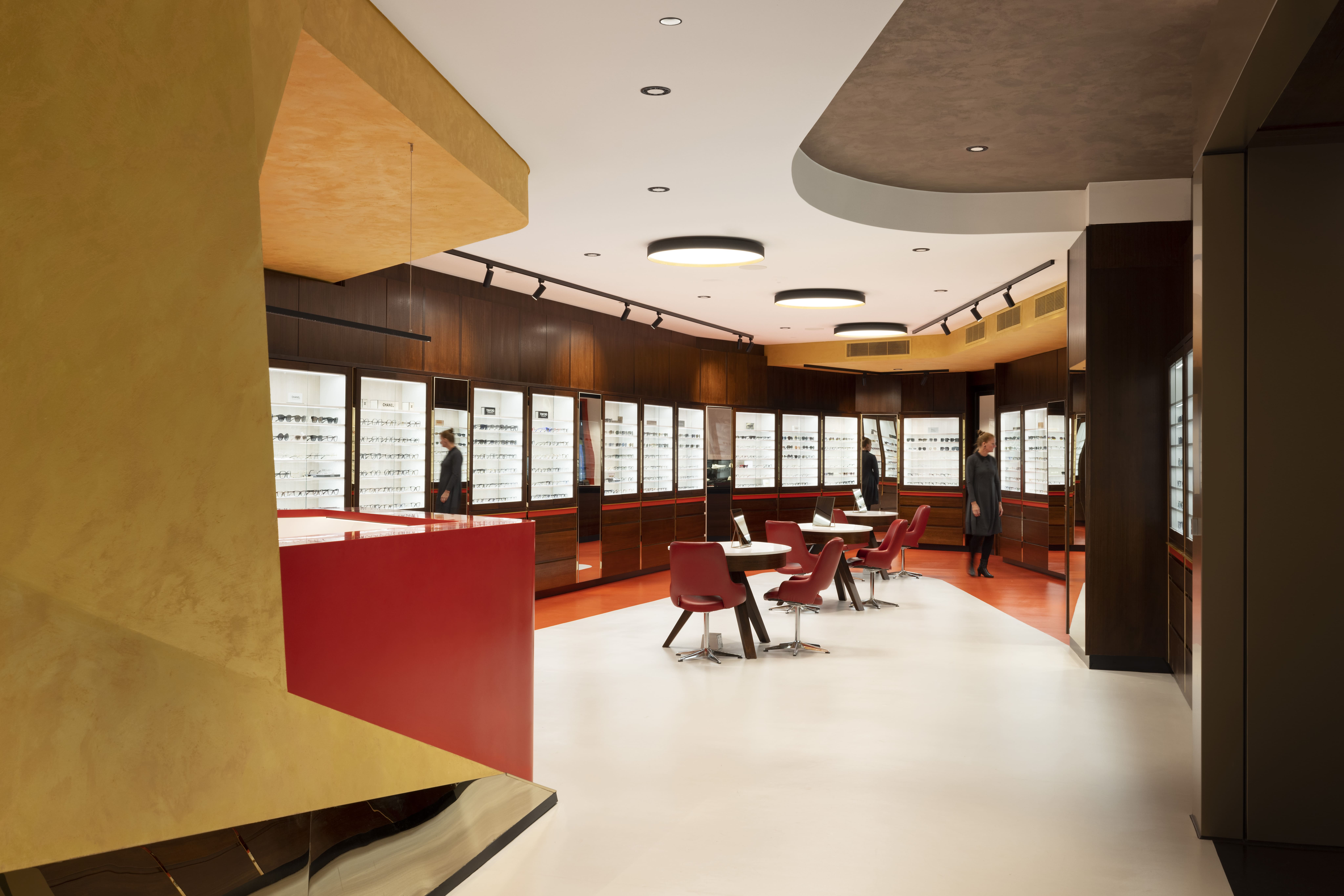 Red and gold Henderson Optical Retail shop designed by On Architects