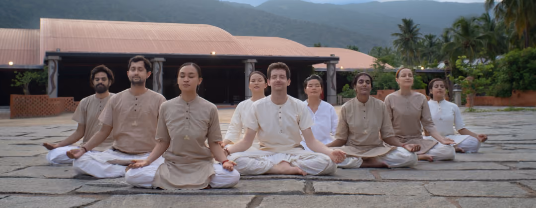 Group practising meditation outdoors