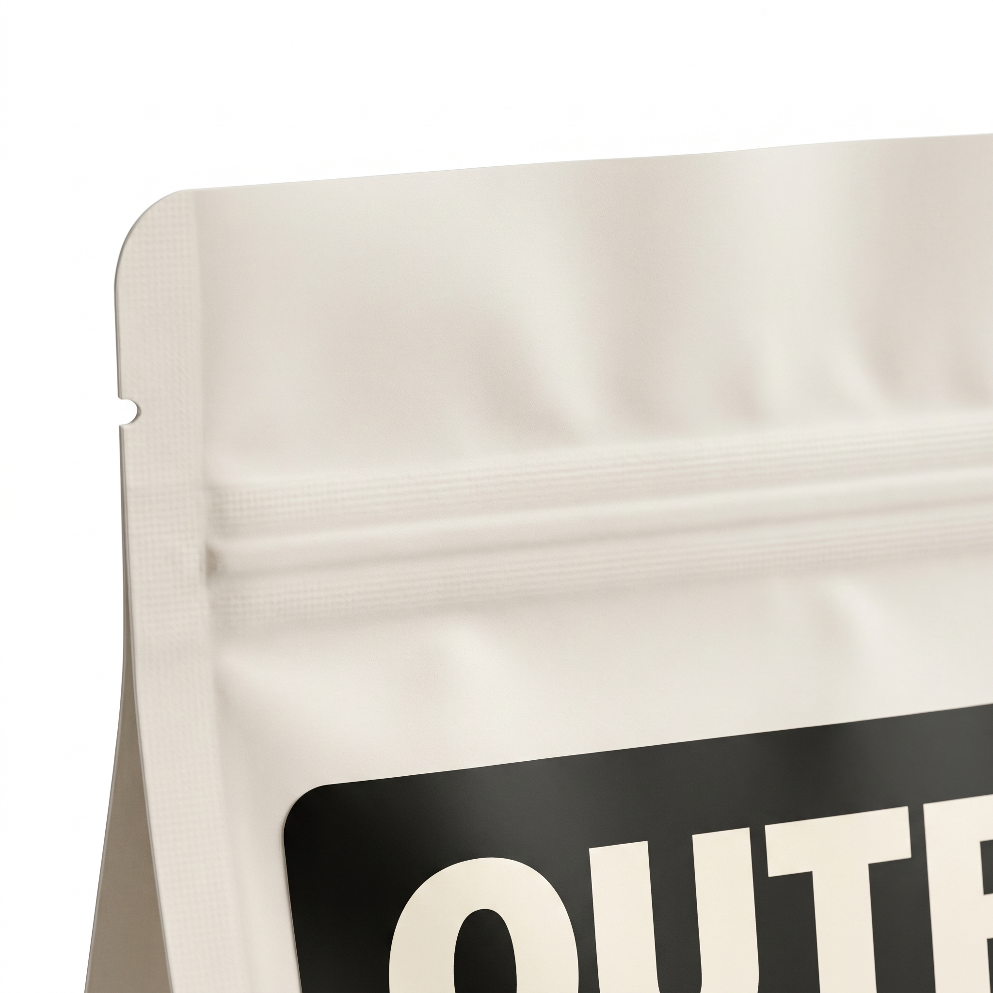 Close-up of a white resealable pouch with partial black label showing large white text.