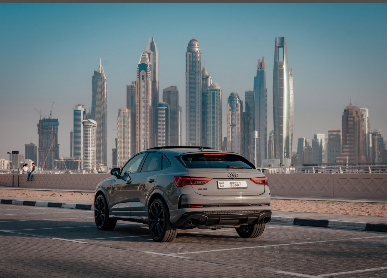Audi SUV parked with Dubai's modern skyscrapers in the background