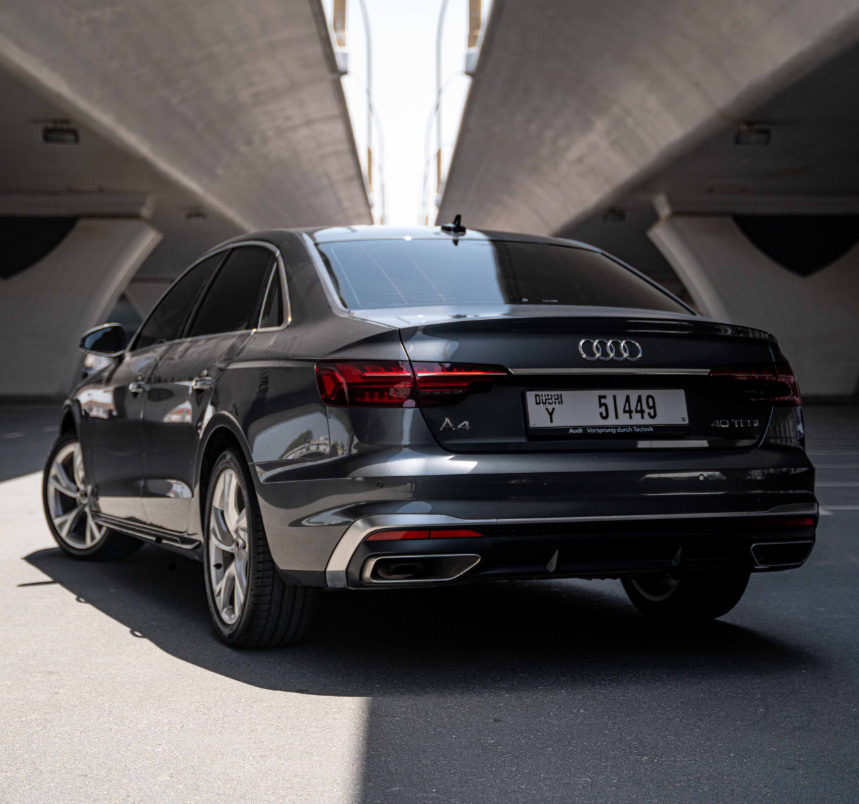 Black Audi A4 parked in a modern concrete architectural tunnel