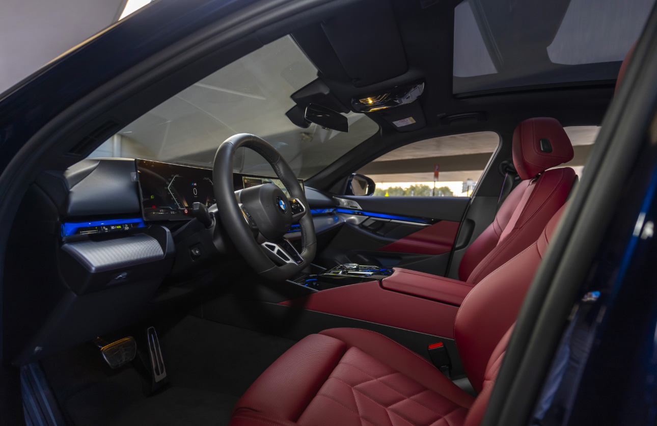 BMW interior with red leather seats and blue ambient lighting