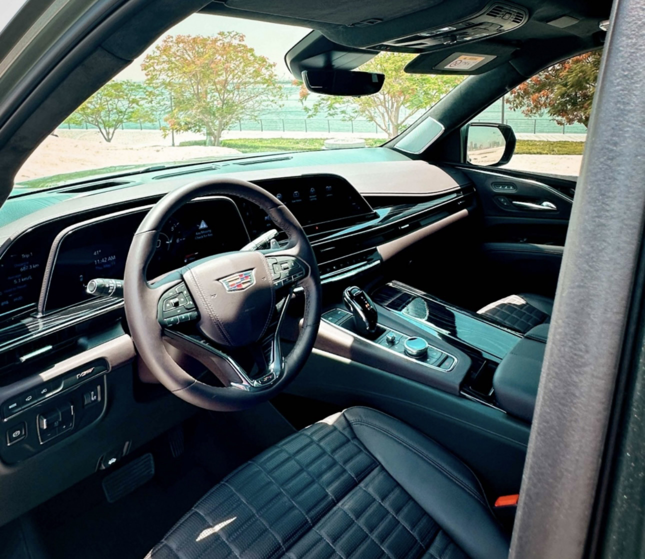 Interior of a luxurious Cadillac with black leather seats and digital dashboard