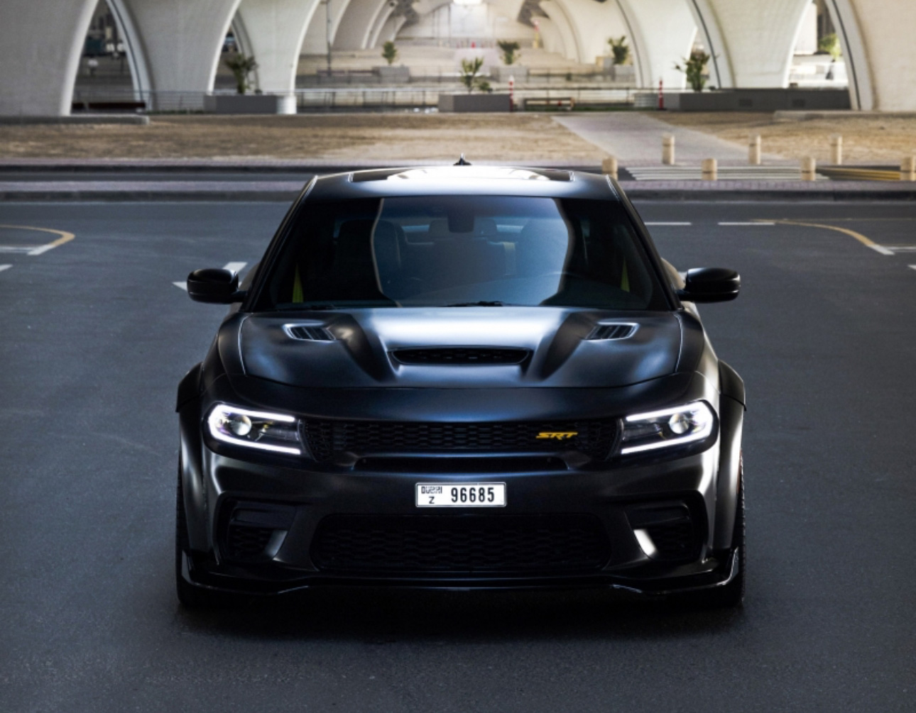 Black muscular Dodge Charger SRT with aggressive front design parked