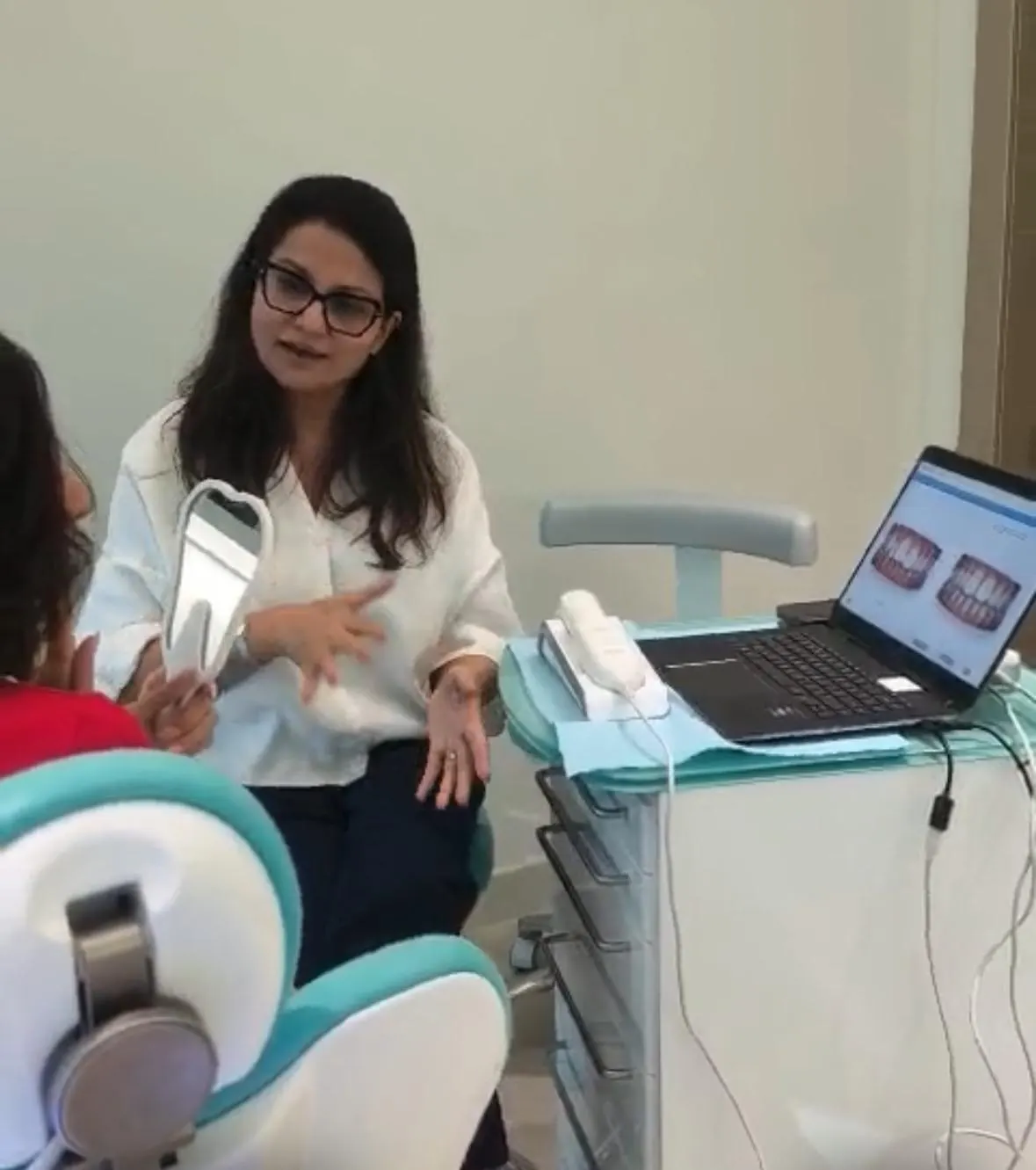 Dr Aisha Ahmed talking a patient through their treatment options at Sale Dental Spa
