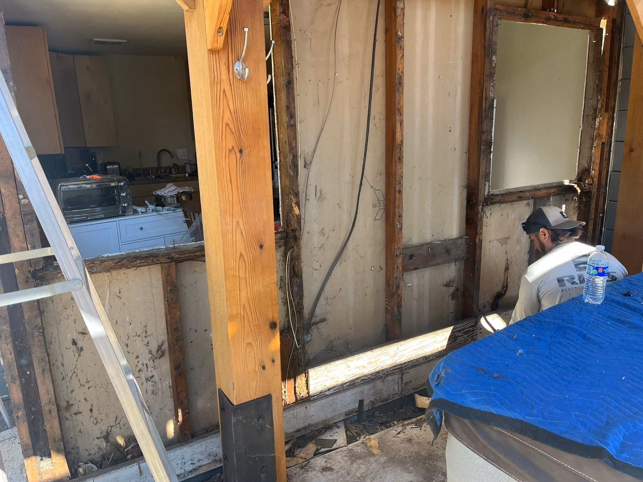 Interior wall opened for framing and structural repair during water damage restoration