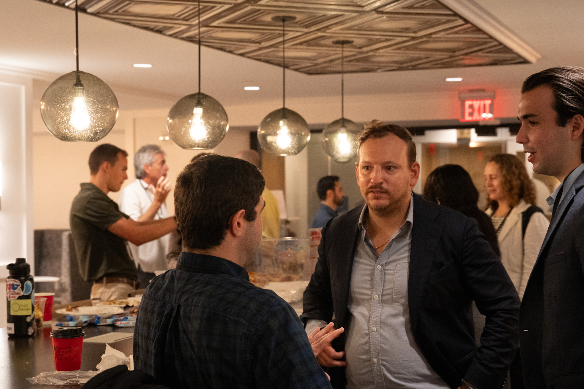 Attendees networking under pendant lights