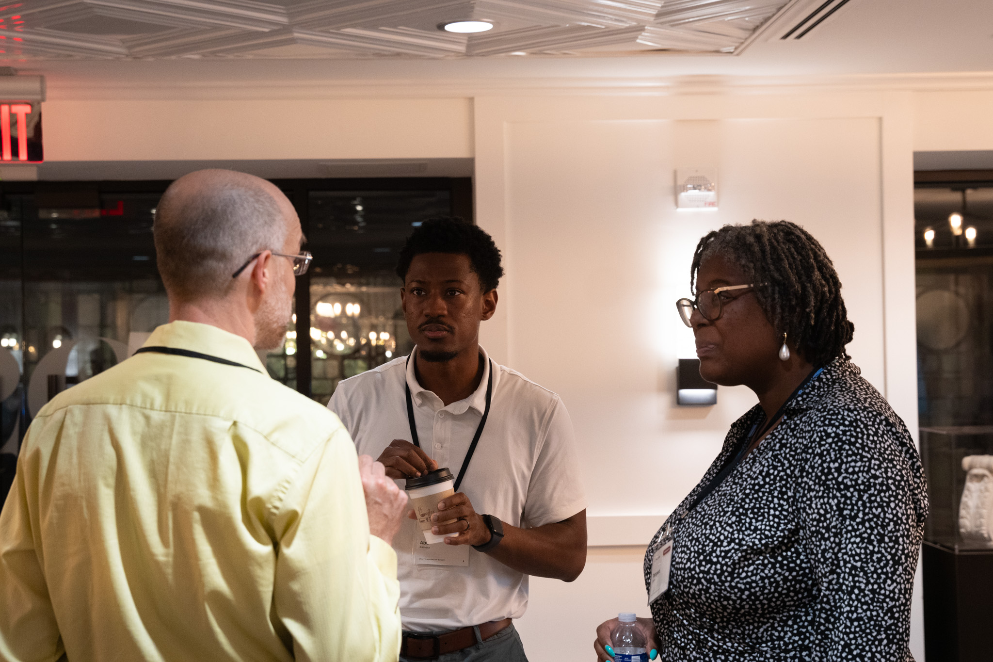 Three attendees in conversation at the break