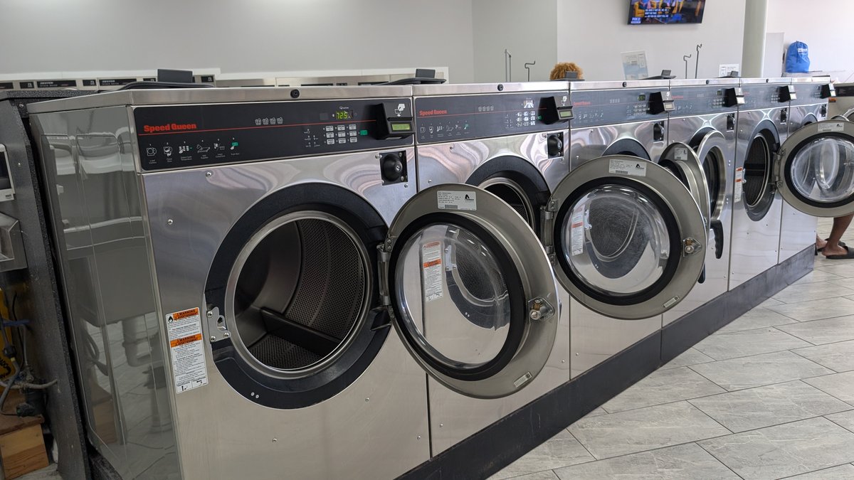 Speed Queen washers with open doors inside Lafayette Laundromat
