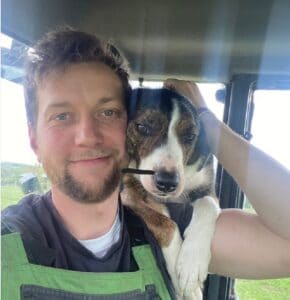 Man with dog in tractor