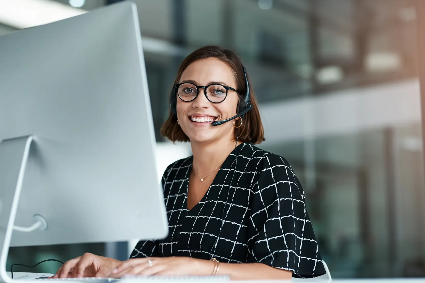 Help desk agent on a headset taking a support call