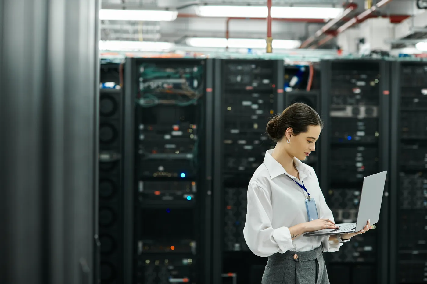 NOC engineer checking network equipment in a server room