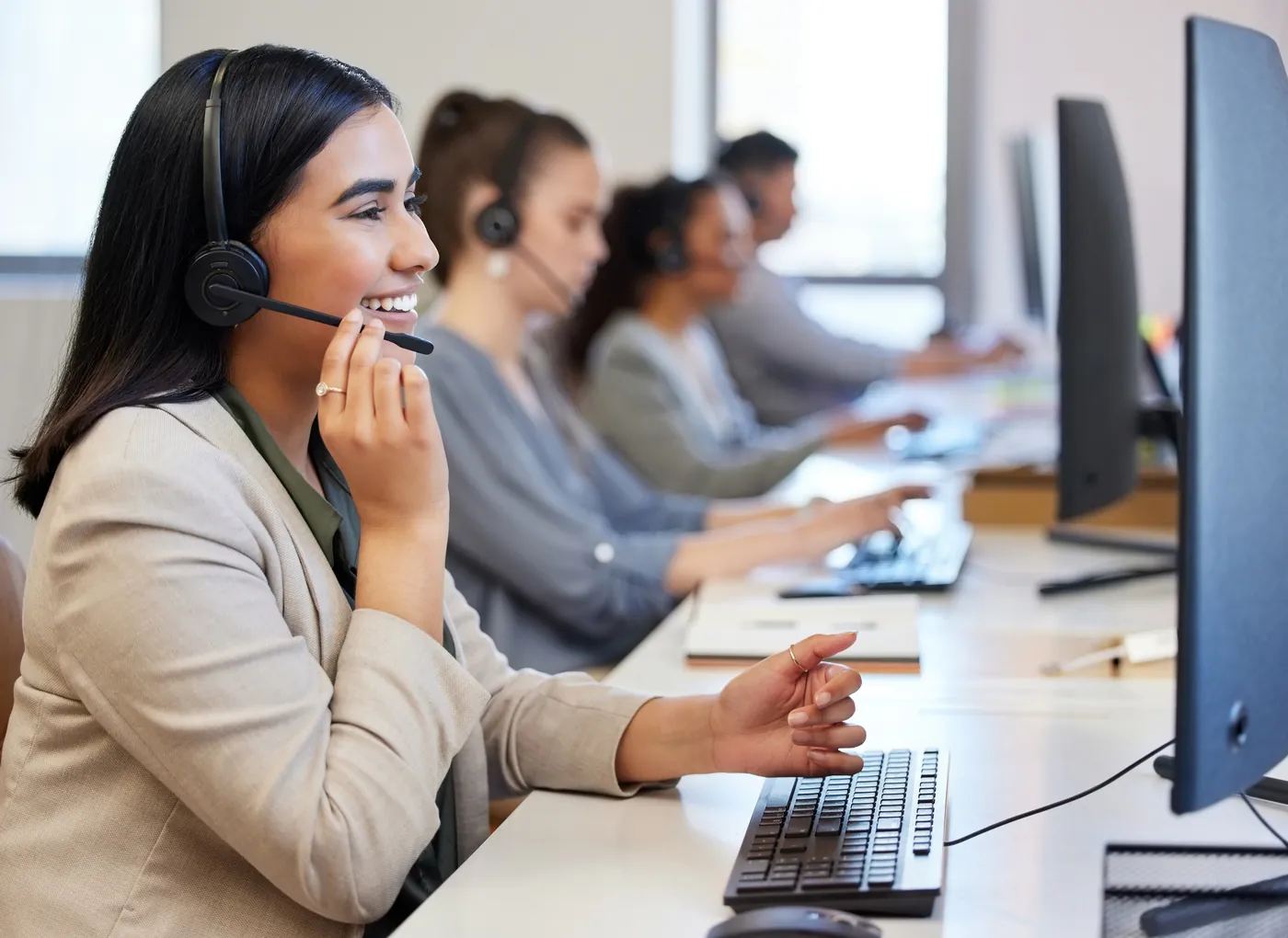 Customer support agents on headsets handling calls on the support floor