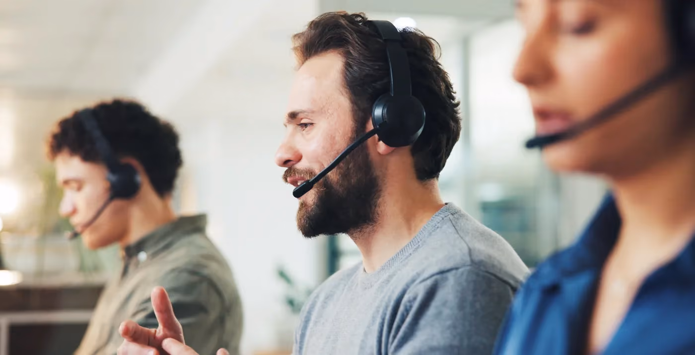 Shared support agents on headsets covering help desk and tech support queues for several clients
