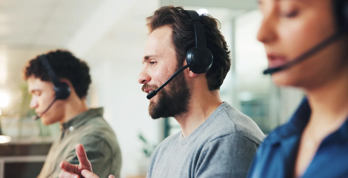 Shared support agents on headsets covering help desk and tech support queues for several clients