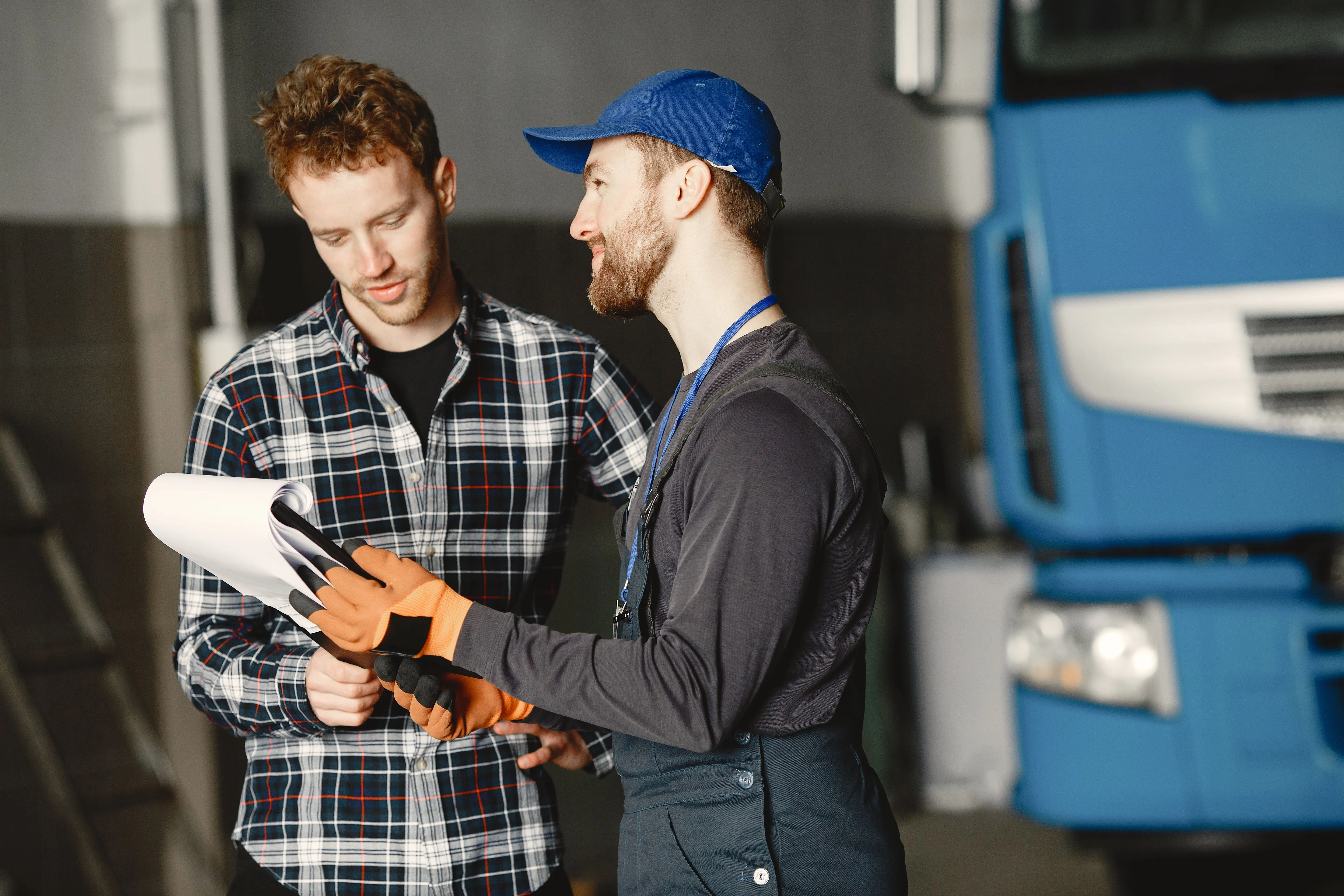 Field service technician reviewing a work order on a tablet with a customer