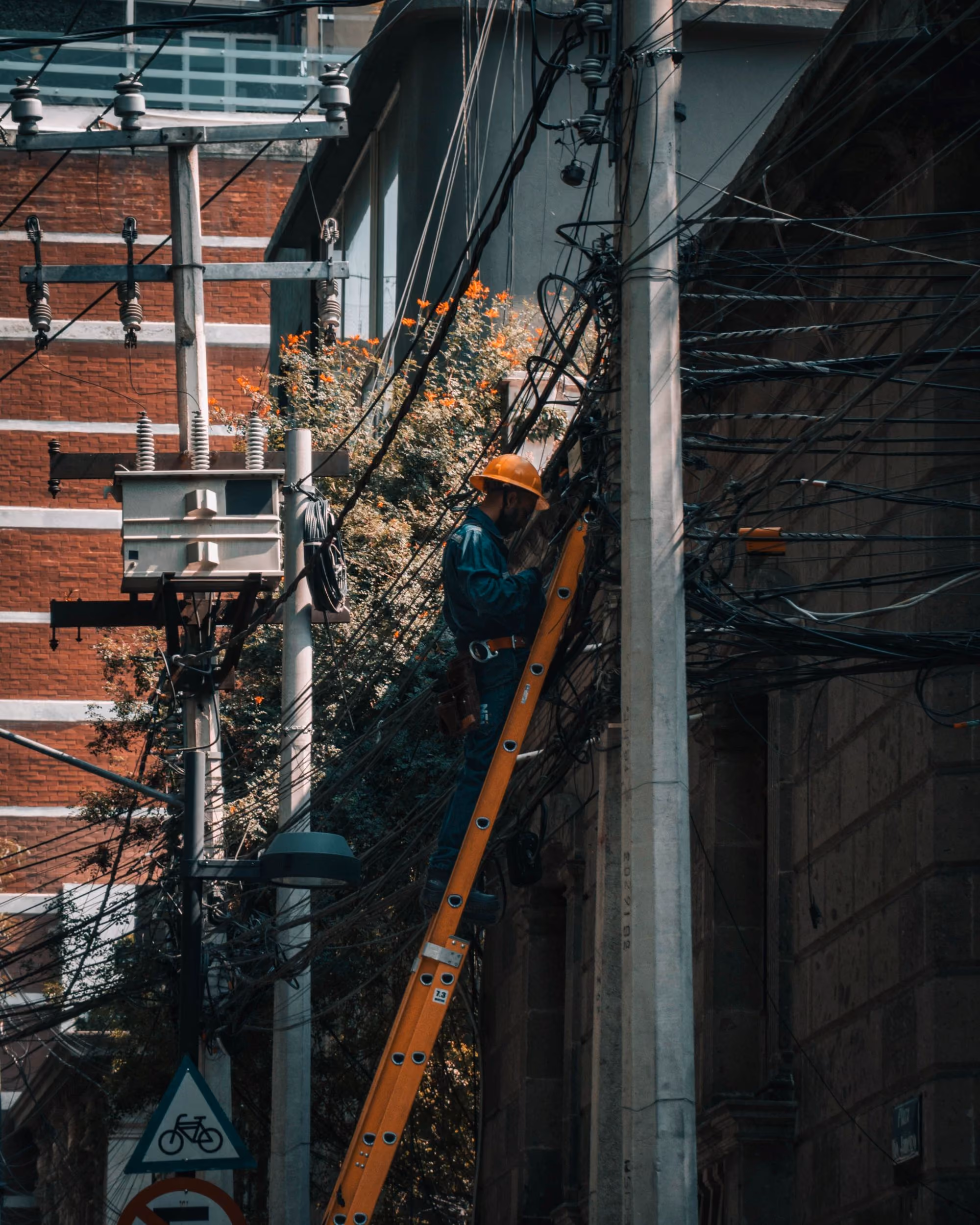 Technician working on overhead utility lines, one of the other industries CallTek supports