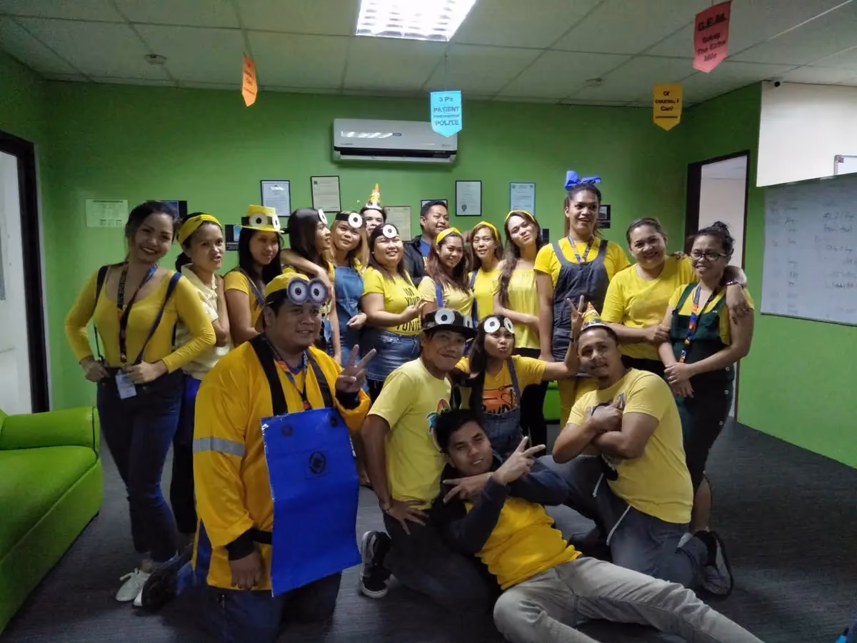 A team dressed as Minions for a themed office celebration