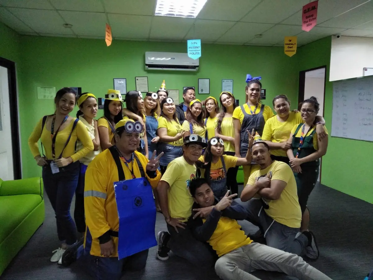 A team dressed as Minions for a themed office celebration