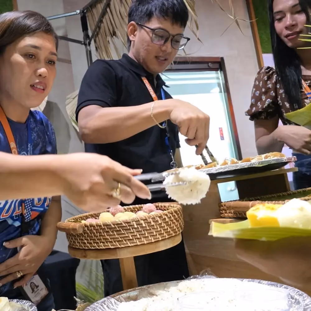 Team members serving food at an office celebration