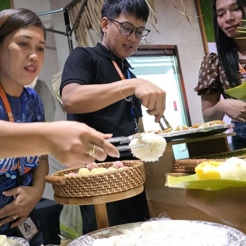 Team members serving food at an office celebration