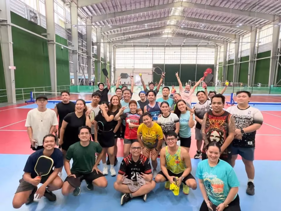 Employees with paddles after a pickleball session
