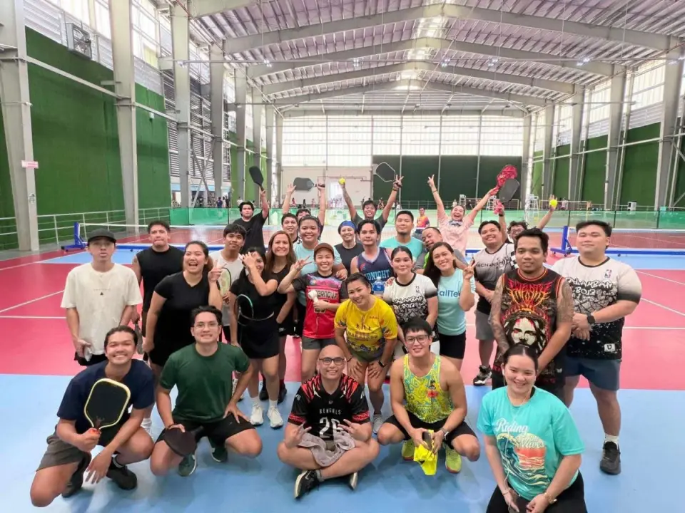 Employees with paddles after a pickleball session