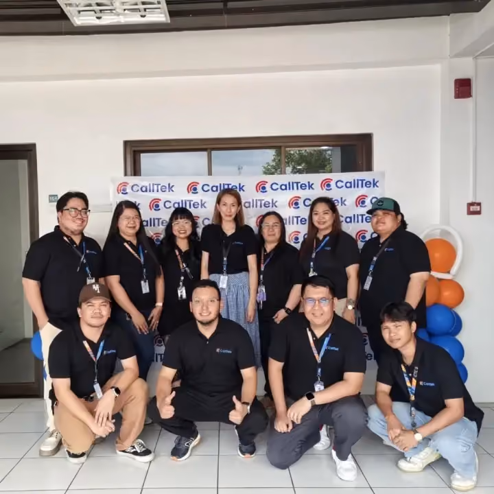 Team members in CallTek polos in front of a CallTek backdrop