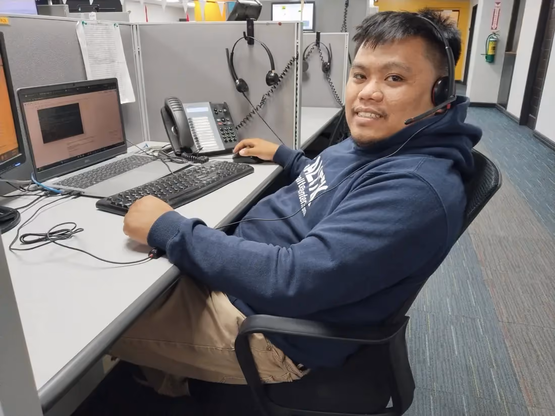Terrence wearing a headset at his workstation